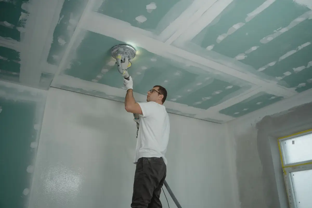 Power sander run across taped ceiling seams before finishing