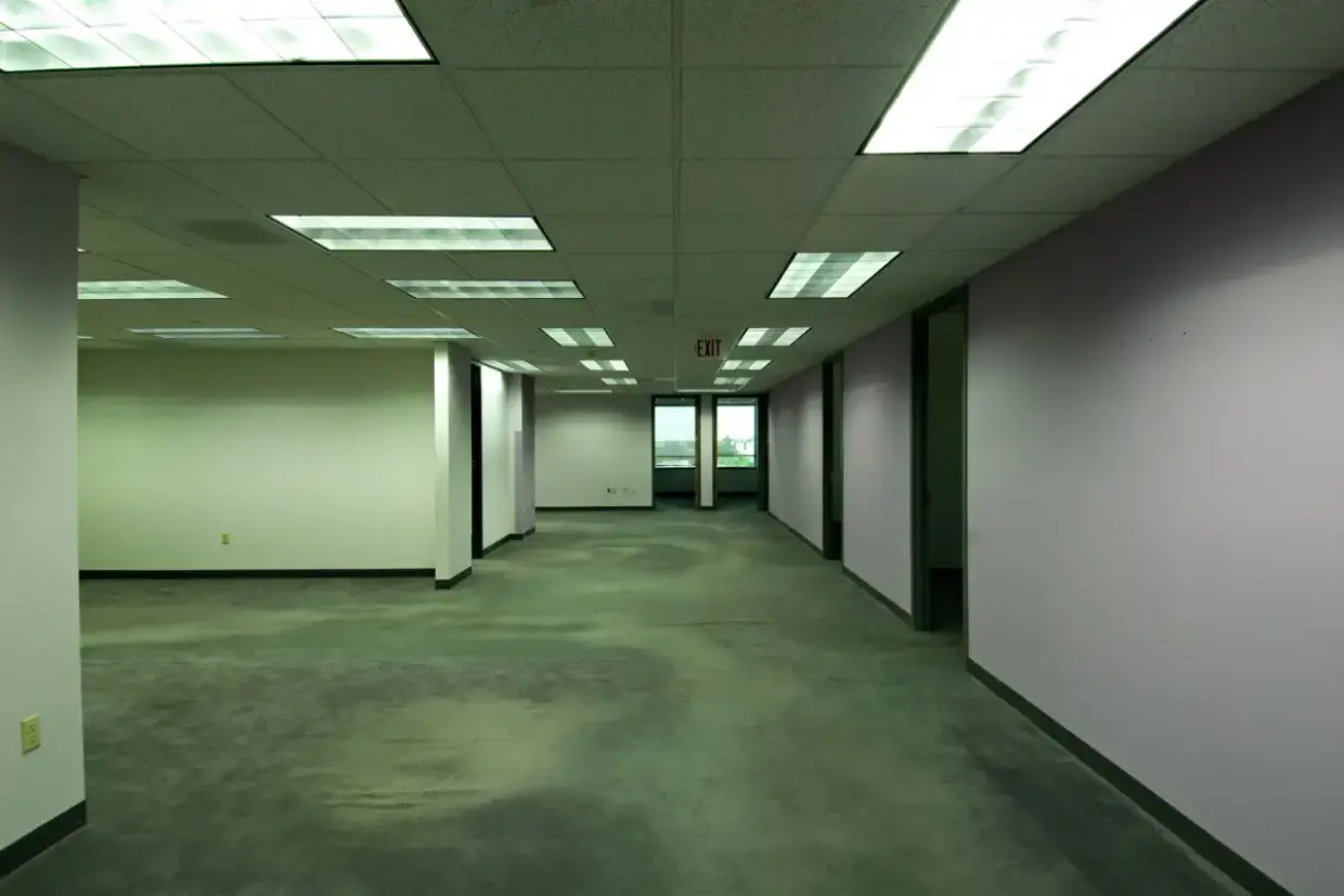 Empty office floor plate with large uninterrupted wall surfaces awaiting finishing