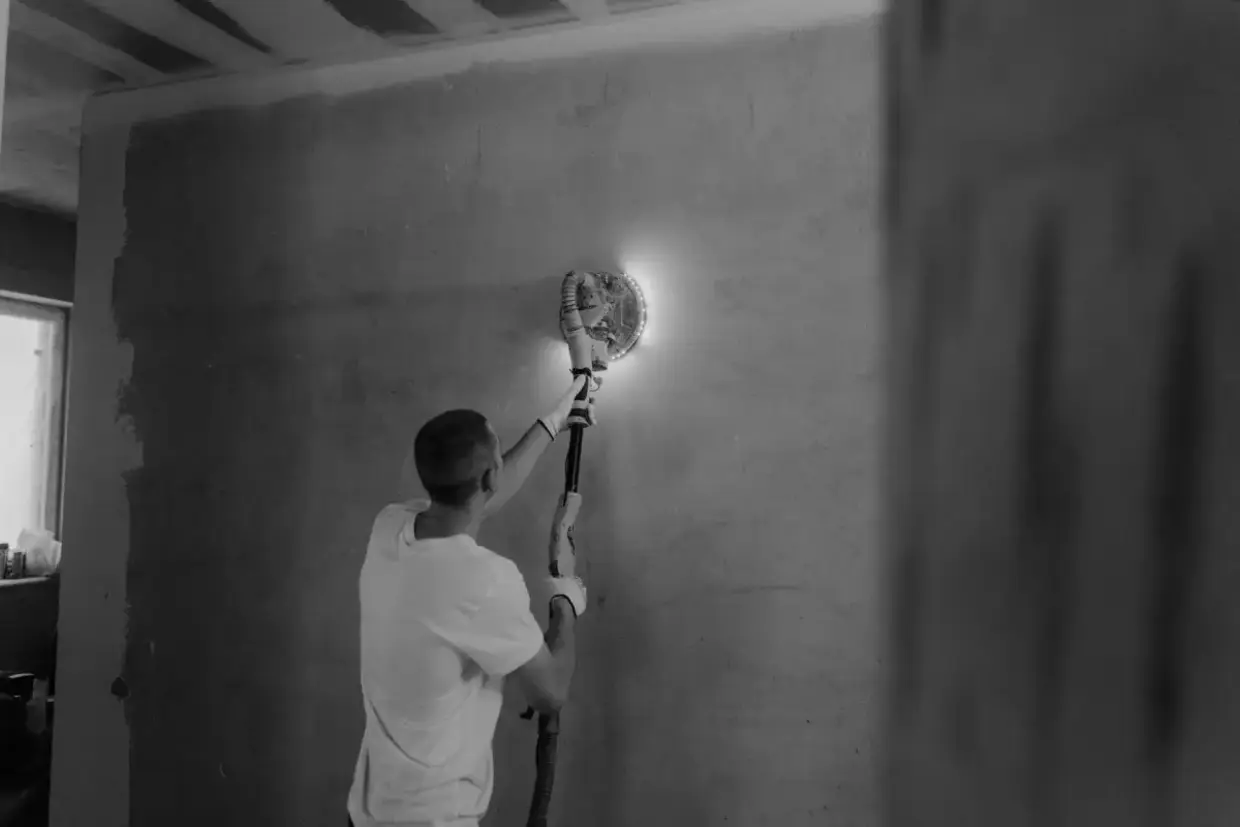 Drywall finish sanded smooth with a power sander before priming