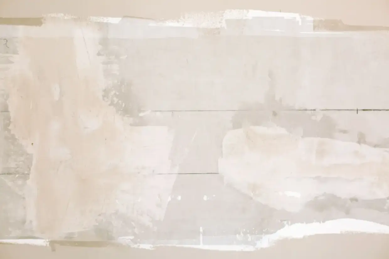 Drywall patch in place before the surrounding texture is matched