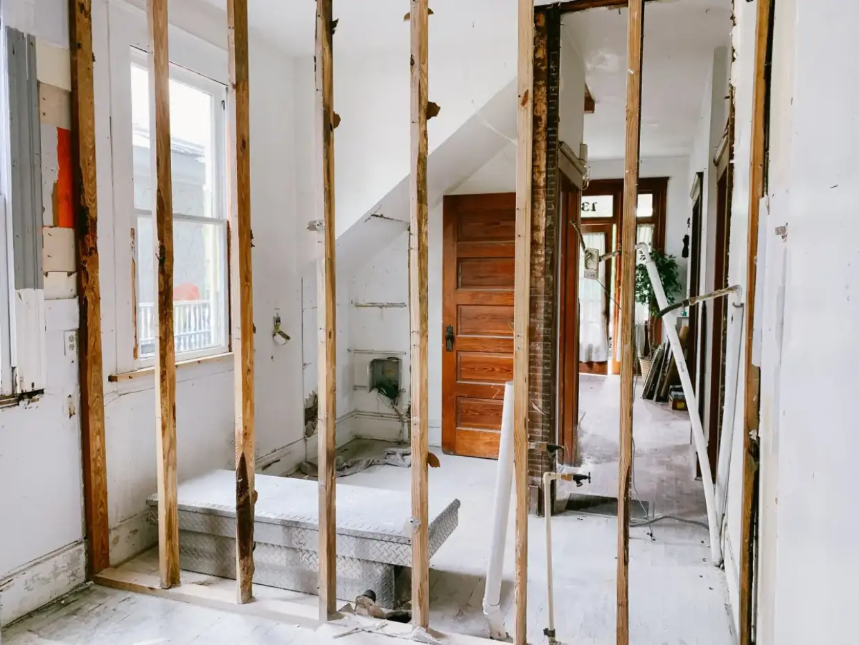 Framing left exposed and drying after water-damaged drywall was removed